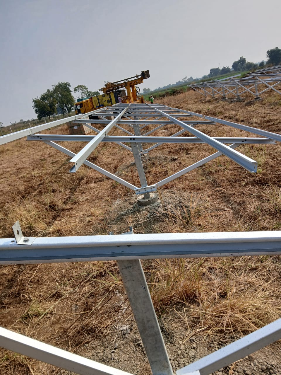 Module mounting structure frame assembled on the ground with a piling rig working behind