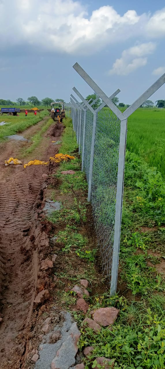 Line of galvanised mounting posts running beside an open cable trench